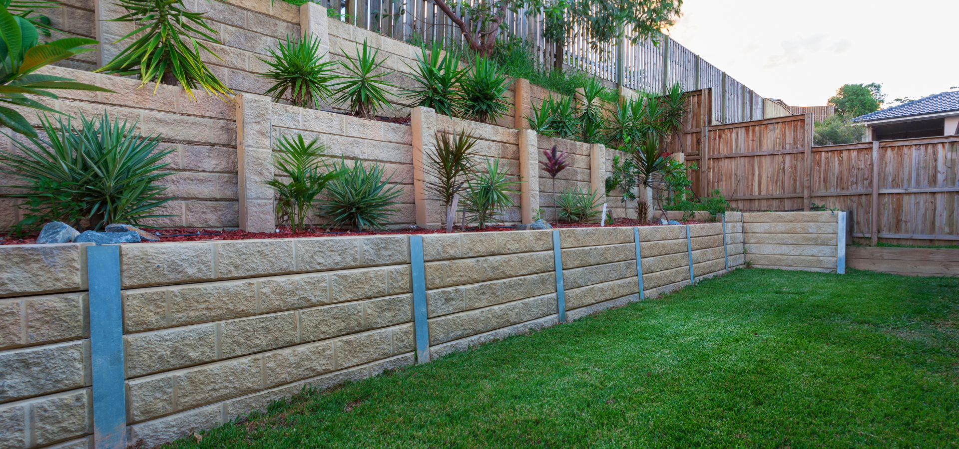 Retaining walls with multiple levels with plants on top of them