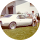 A white car is parked in the grass in a circle.