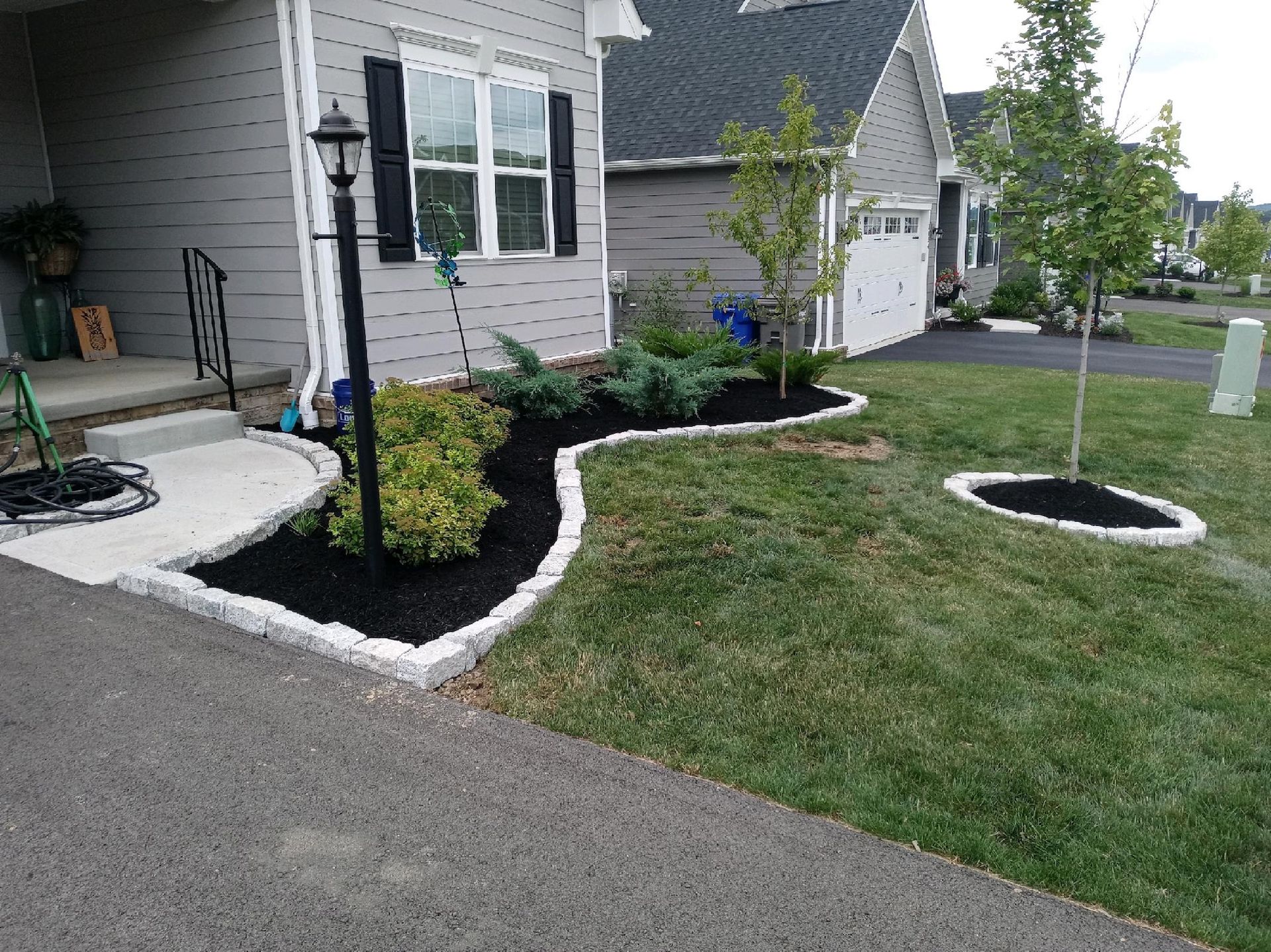 A house with a lush green lawn in front of it.