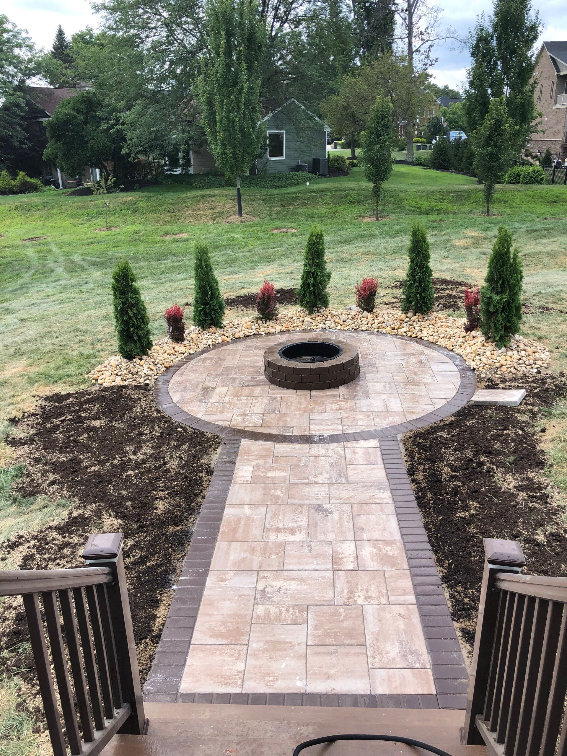 There is a fire pit in the middle of the patio.
