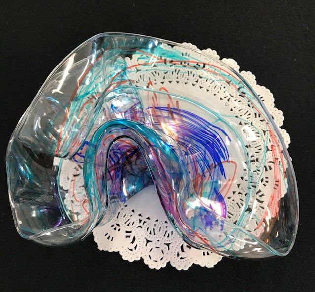 A clear glass bowl with a rainbow design on it