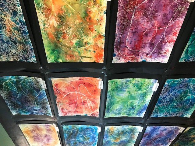 A ceiling with a bunch of colorful paintings on it
