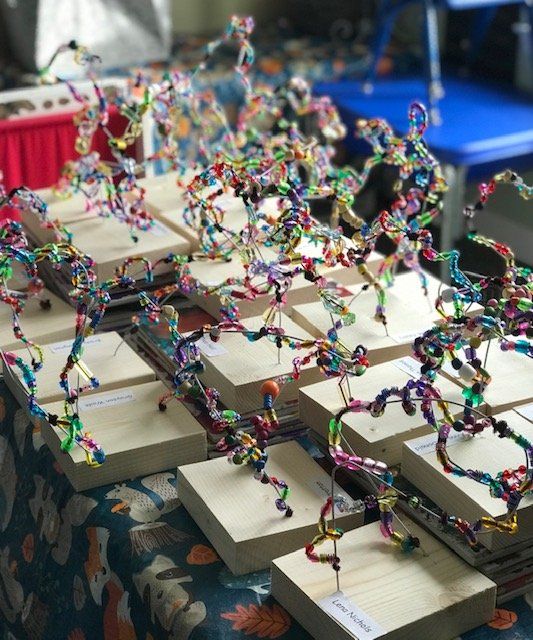 A table with a bunch of colorful sculptures on it