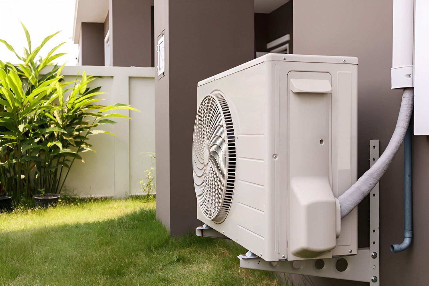 Air Conditioning Unit Mounted On A Gray Wall Outside A House