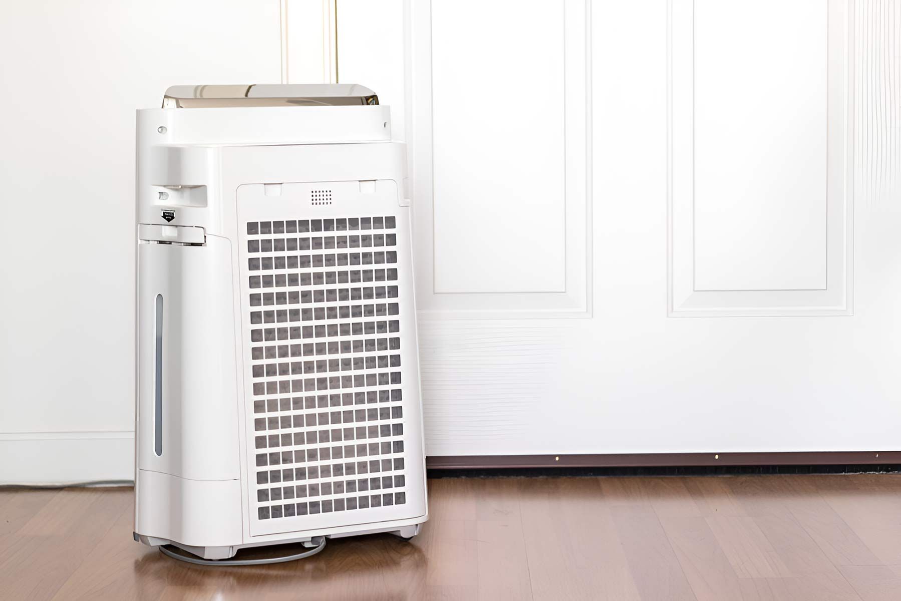 A White Air Purifier Is Sitting On A Wooden Floor — Jordan Wheatland Air Conditioning & Refrigeration In Forbes, NSW
