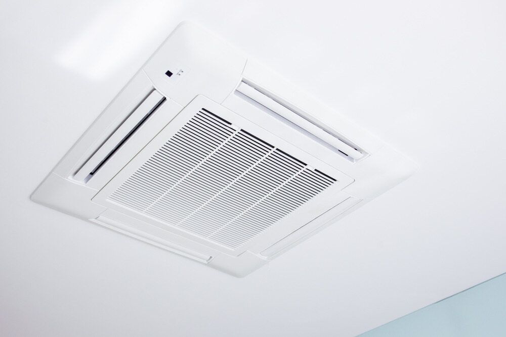 A White Air Conditioner Is Mounted To The Ceiling Of A Room — Jordan Wheatland Air Conditioning & Refrigeration In Dubbo, NSW