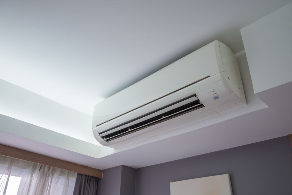 A White Air Conditioner Is Hanging From The Ceiling — Jordan Wheatland Air Conditioning & Refrigeration In Dubbo, NSW