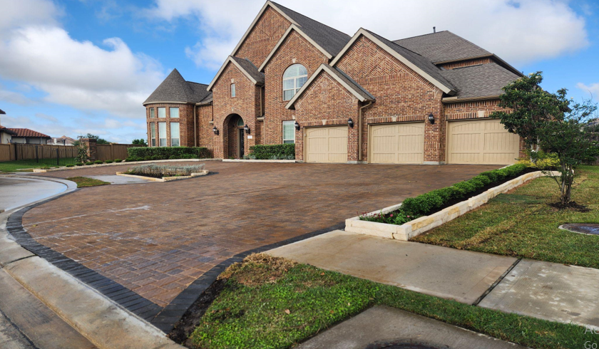 A walkway leading to a building in the middle of a field