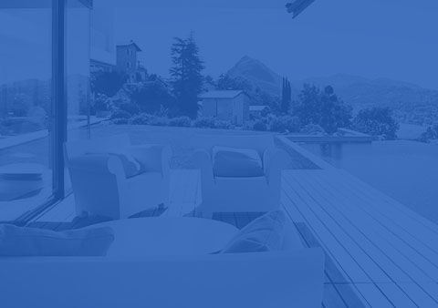 A blue background with a patio with chairs and a swimming pool in the background.