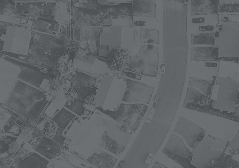 An aerial view of a residential area with lots of houses and trees.