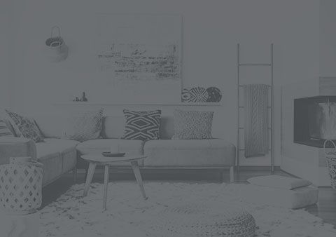 A black and white photo of a living room with a couch and a table.