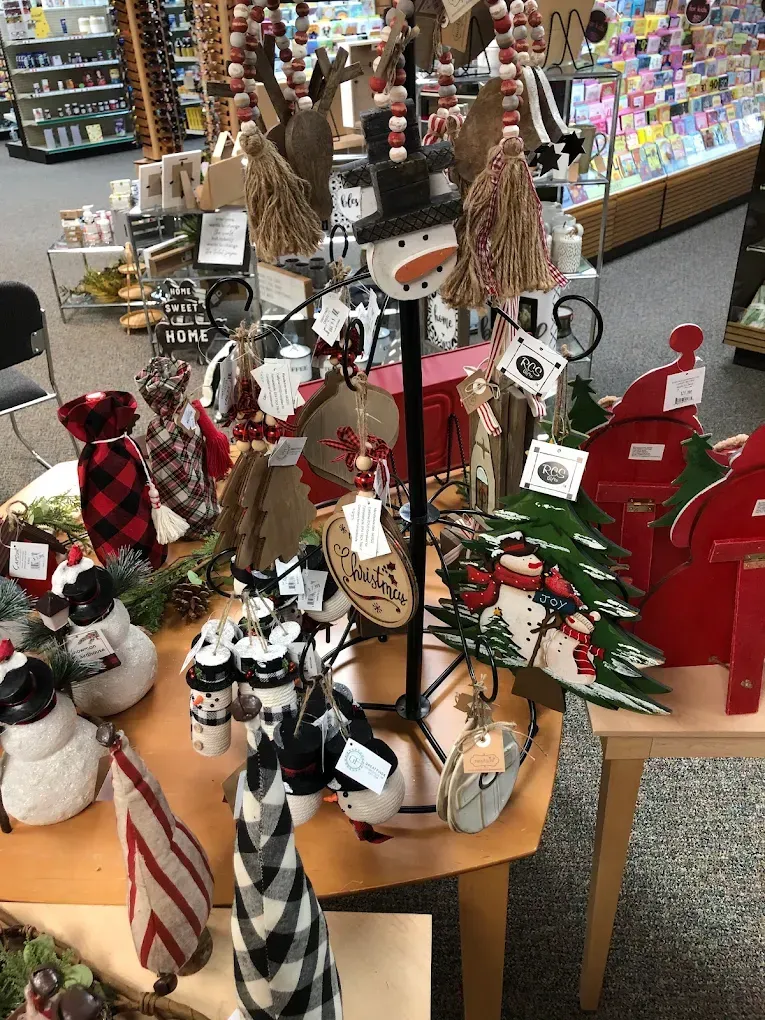 A display of christmas decorations on a table in a store.