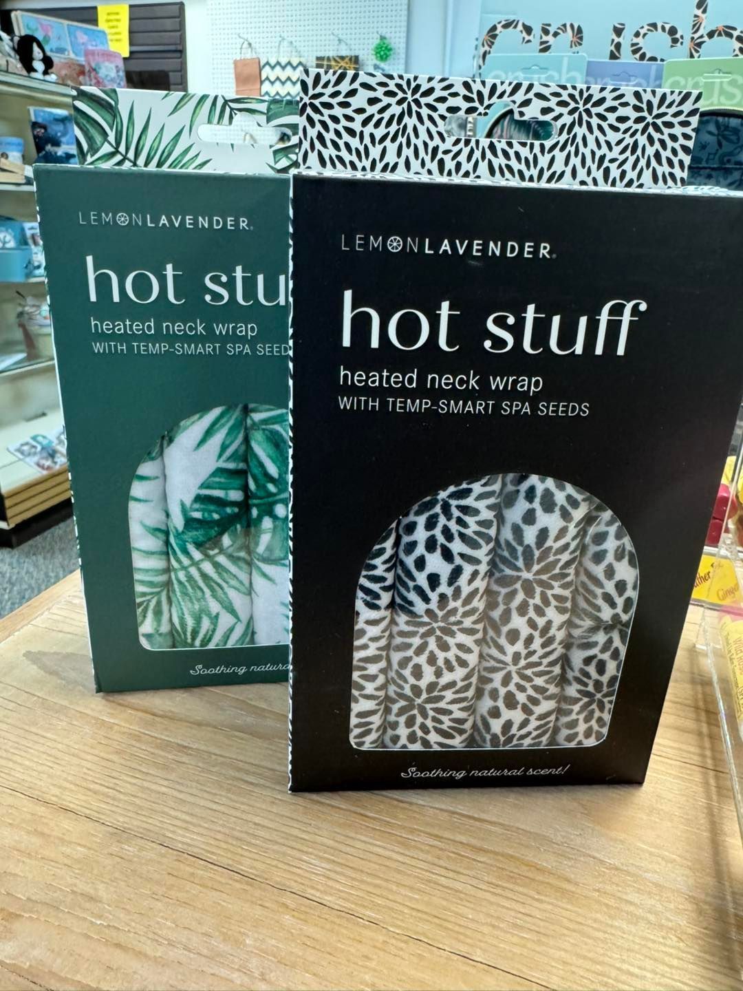 Two boxes of hot stuff are sitting on a wooden table.