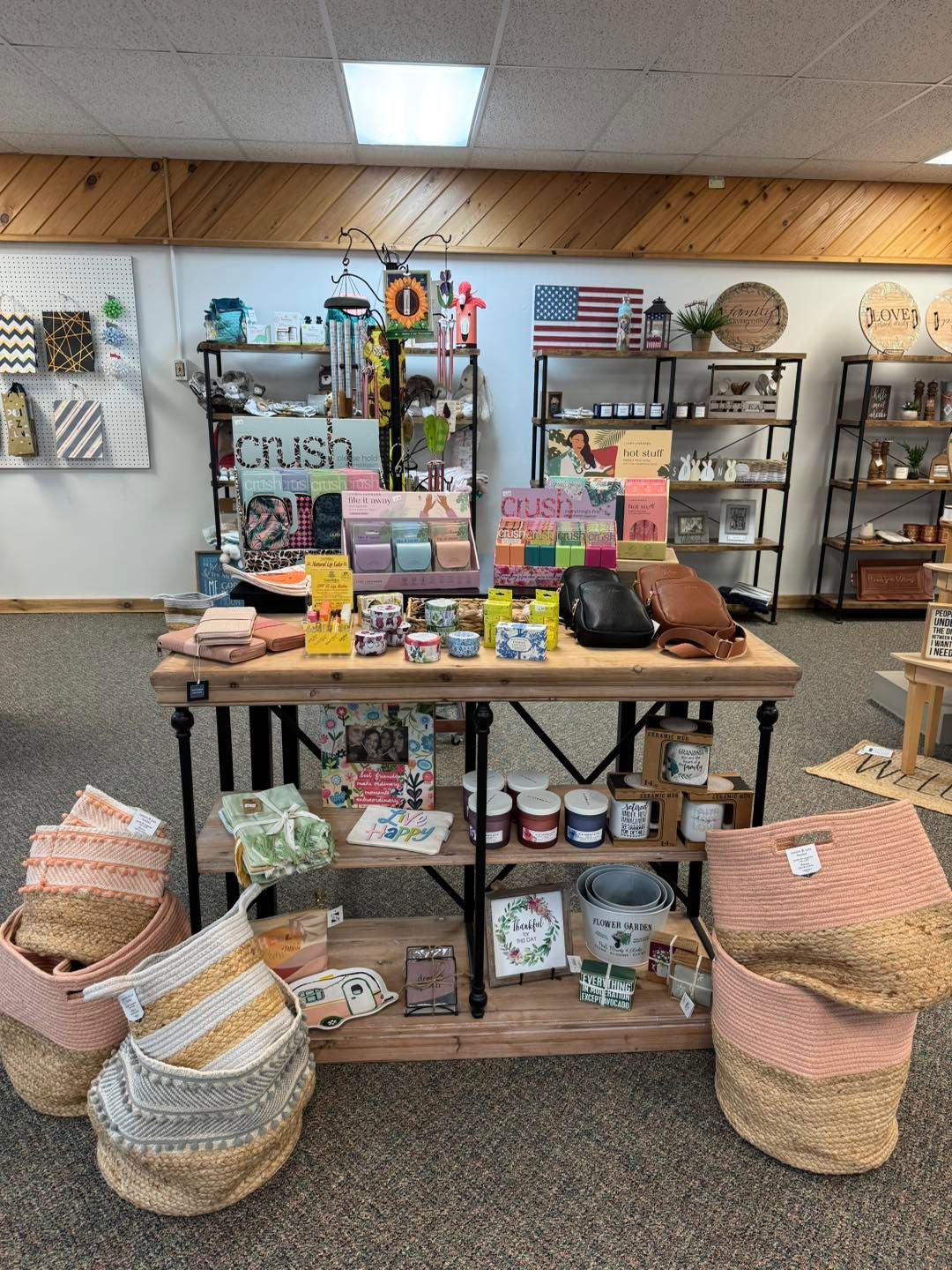 There is a table with a lot of items on it in a store.