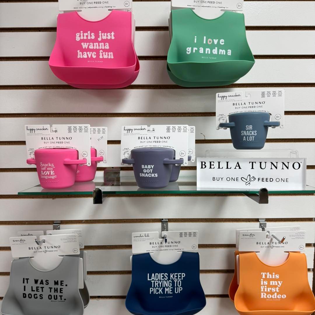 A display of bibs with one that says i love grandma