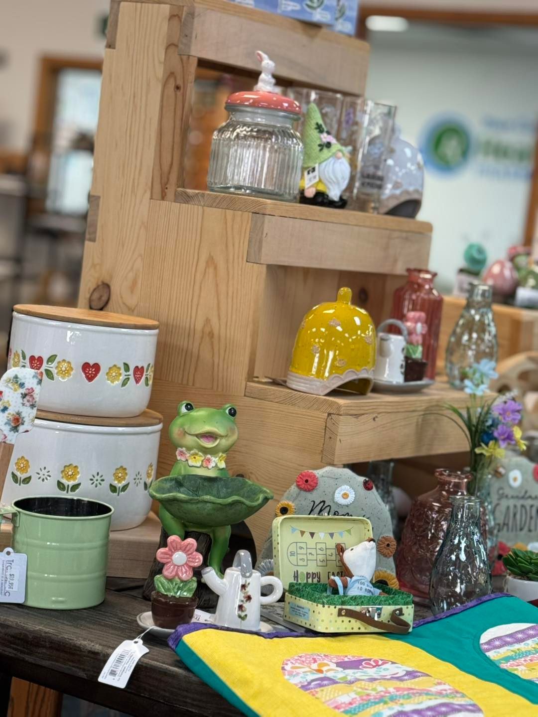 A table topped with a variety of items including a frog figurine.
