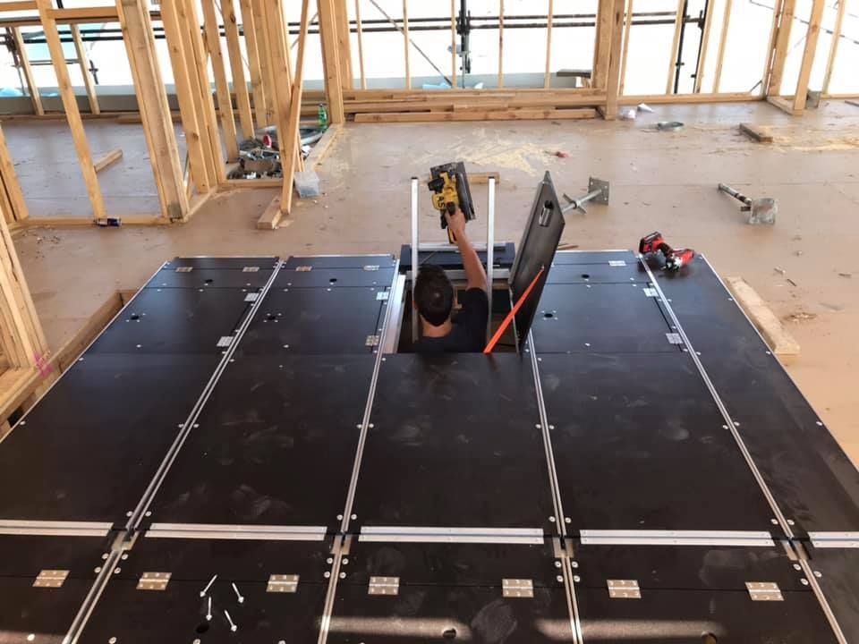 Two-story house under construction, with scaffolding around the brick facade.