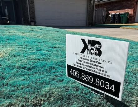 A business sign for KB Landscape & Tree Service, phone number 405.889.8034, placed in a lawn with bright green turf dye.