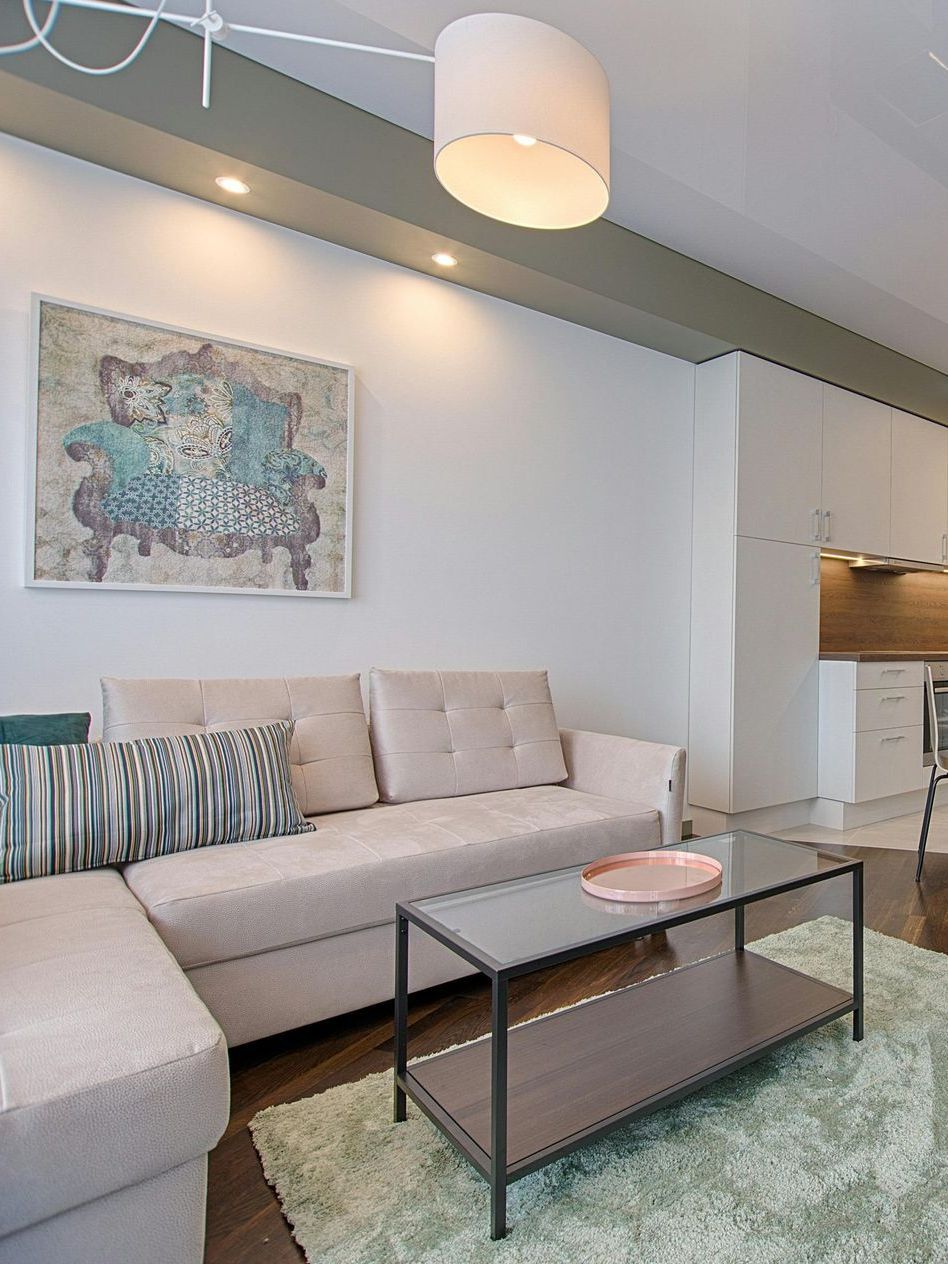 A clean living room with a couch and a coffee table