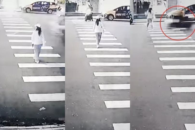 Woman walking in crosswalk; car speeds by quickly.
