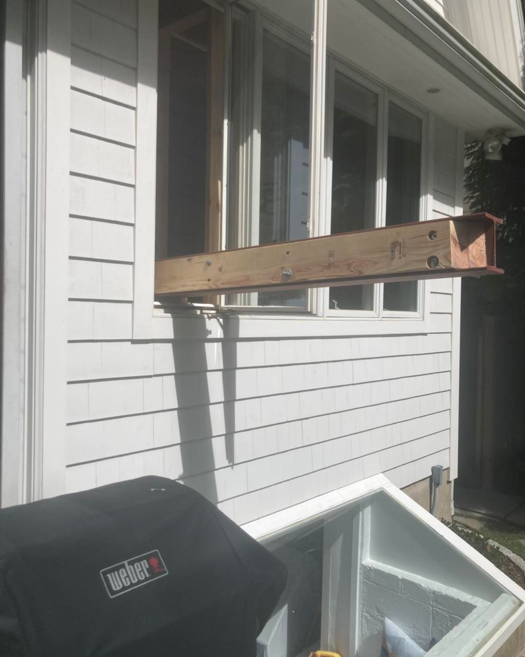 A Wooden Beam Extends from a Window