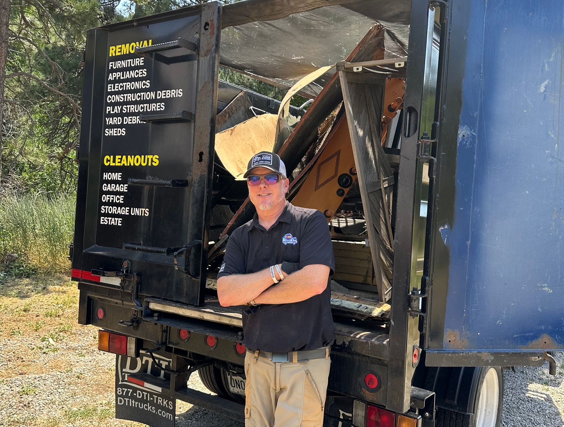 The Colorado Junk Runners owner standing in front of their truck