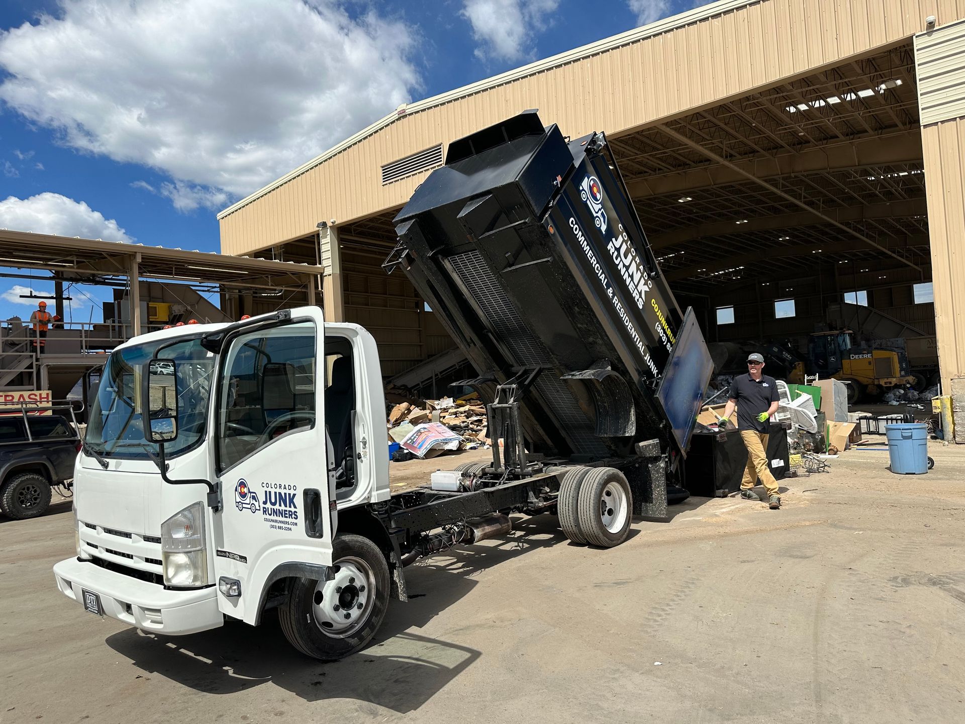 A dump truck is parked in front of a building.