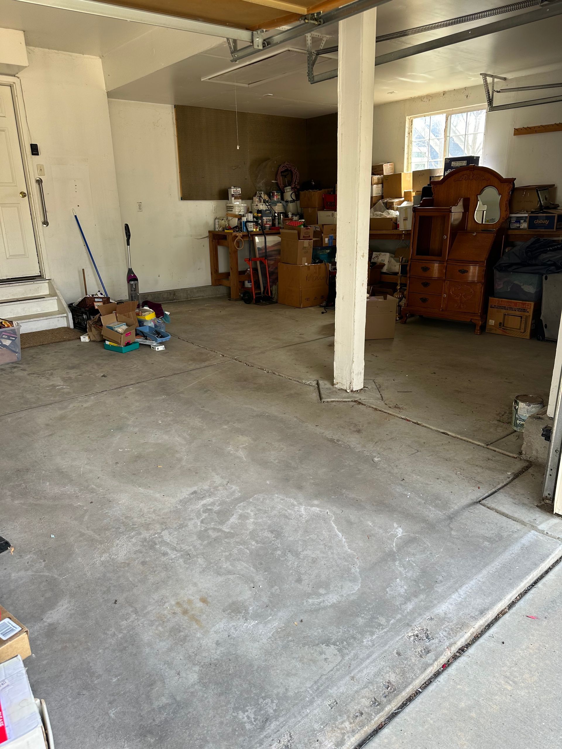 A garage filled with lots of furniture and boxes.