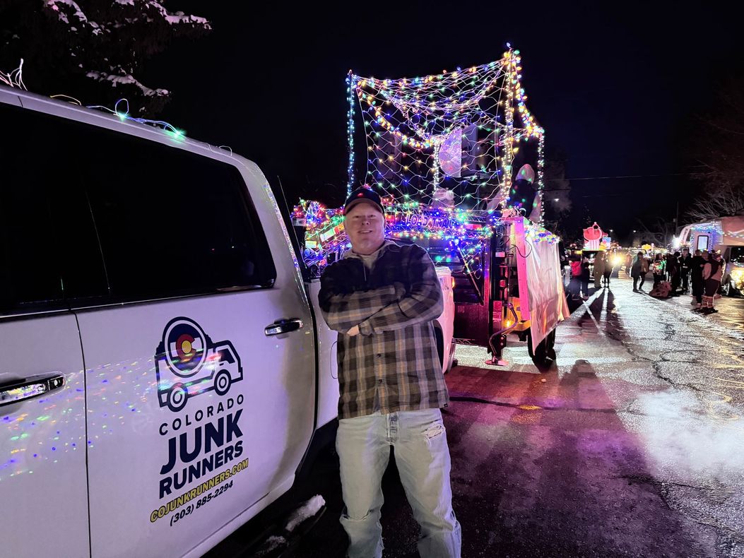 Tom stands next to his truck pulling a float in downtown Louisville for the parade of lights.