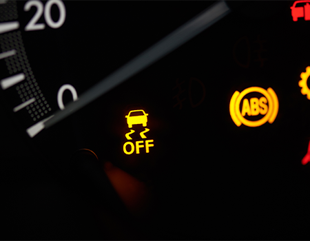 Dashboard with illuminated yellow traction control and ABS warning lights.