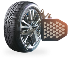 Car tire with wheel alignment equipment attached.