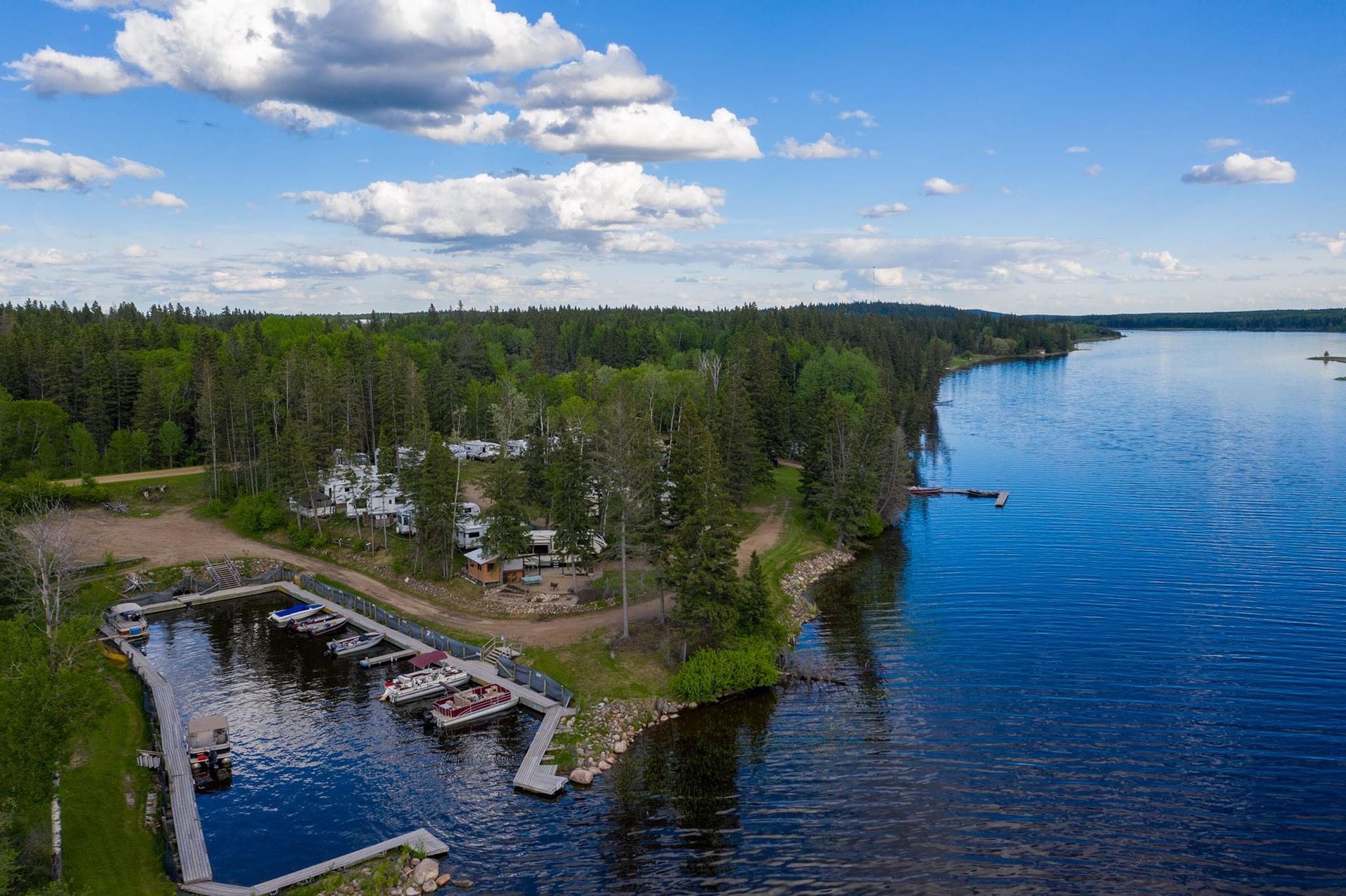An aerial view of a lake with boats docked in the water.