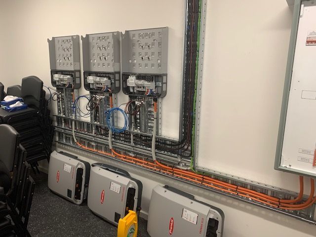 A room with a lot of electrical equipment on the wall.