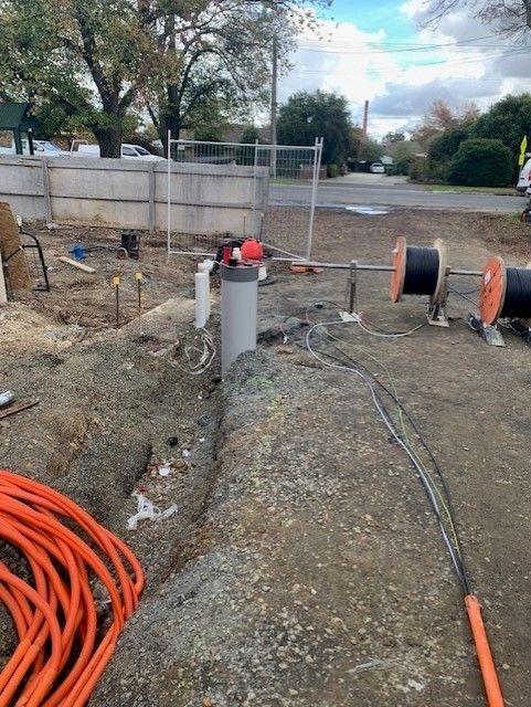 A bunch of electrical wires are laying on the ground