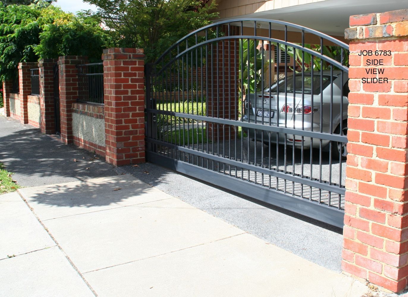 iron gate with brick pillars