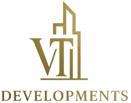 Gold &ldquo;VII Developments&rdquo; logo with stylized skyscraper line art on a white background
