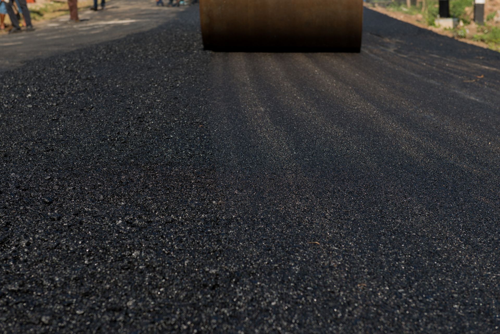 A Roller Rolling Black Asphalt