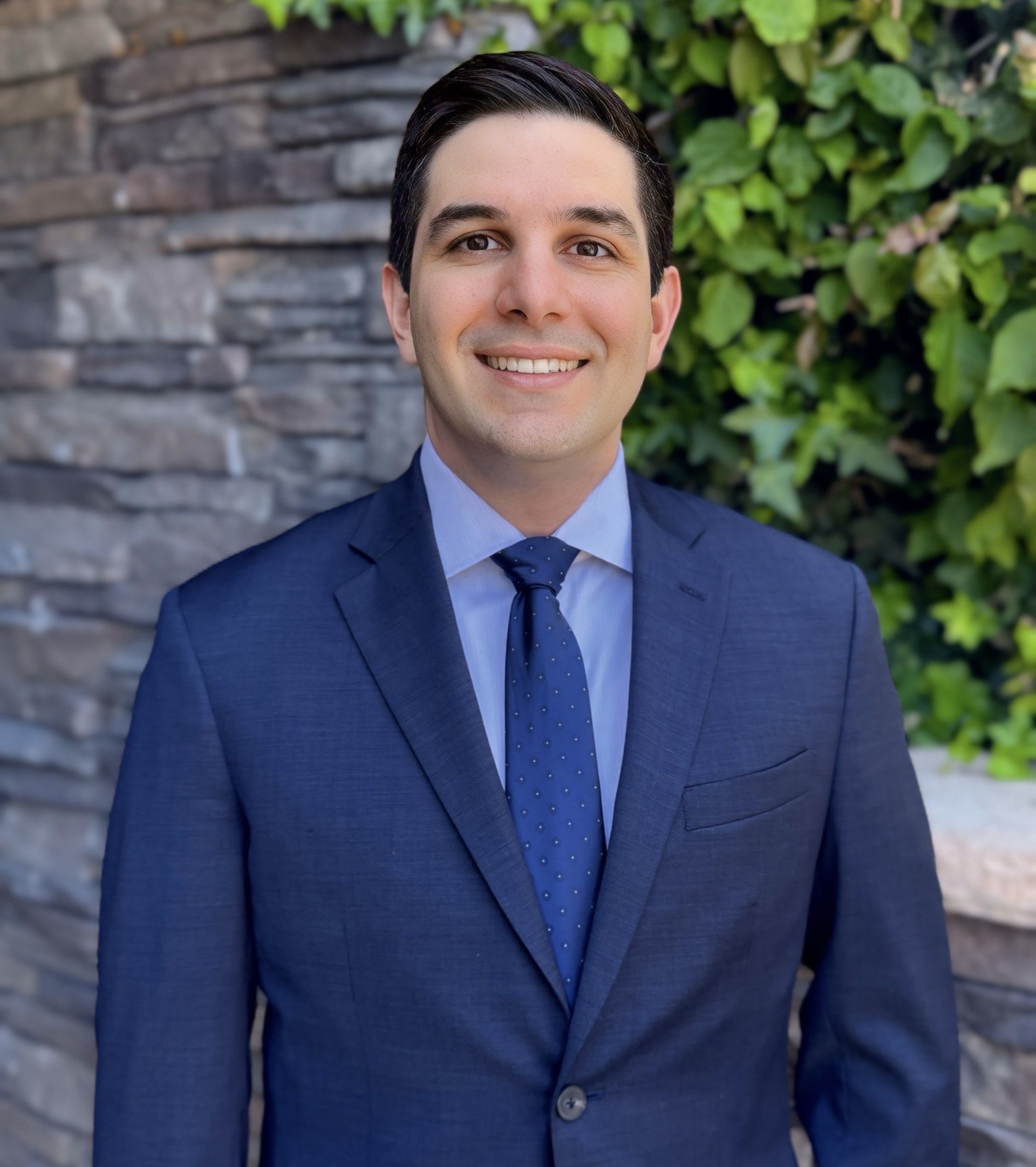 A man in a suit and tie is smiling for the camera.