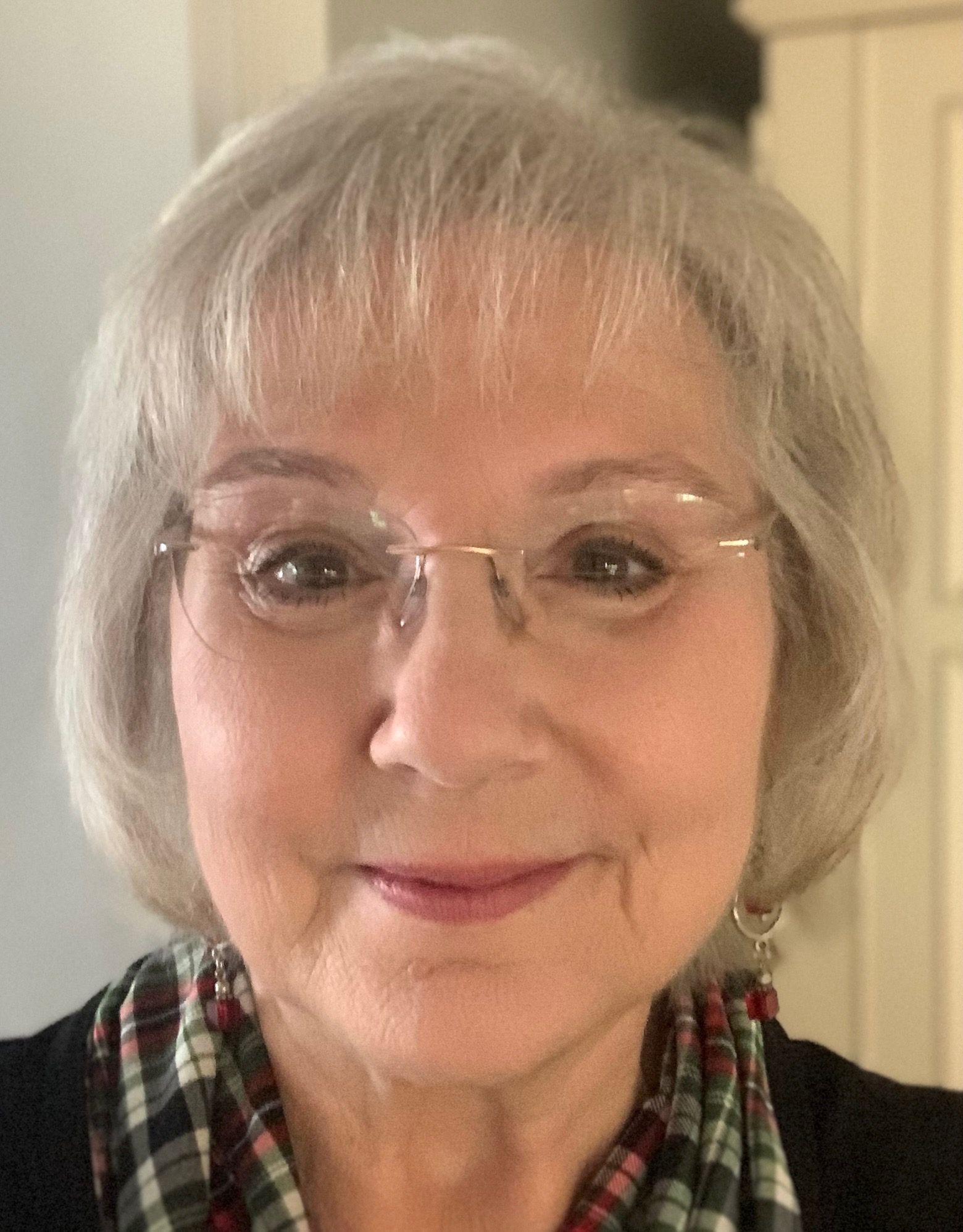 A close up of a woman wearing glasses and a scarf.