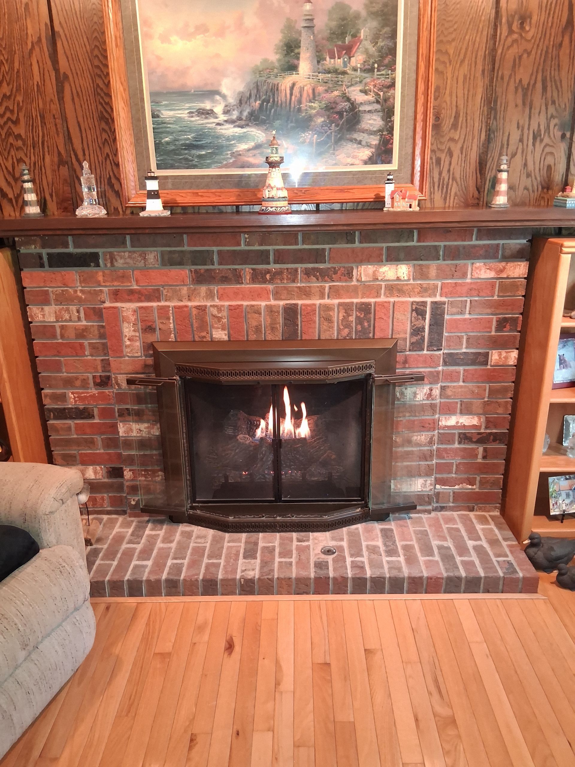 Woman and two children at a table; child touches nose to woman's. Boy mixes something at left, tulips in a vase.