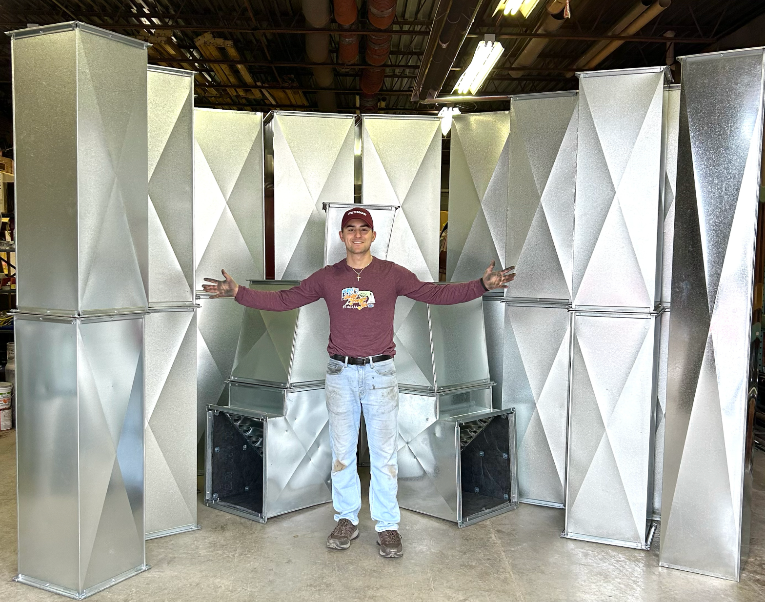 Couple on a couch with a dog and guitar, drinking wine in a cabin-like setting.