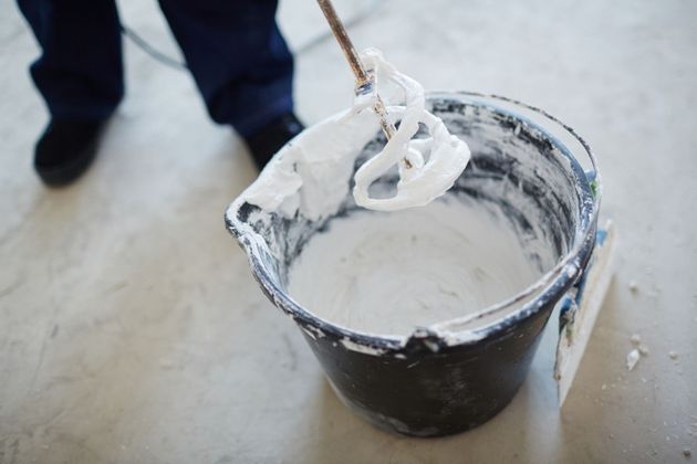mixing drywall mud in bucket