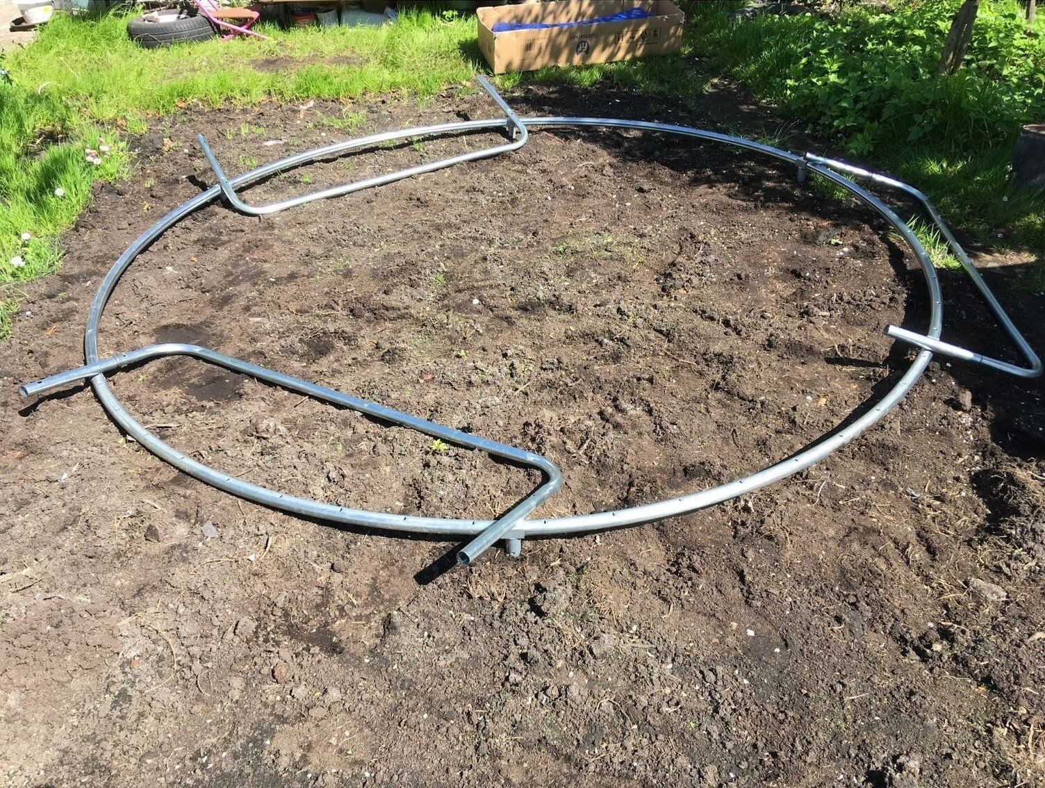 Trampoline frame on ground ready to be assembled