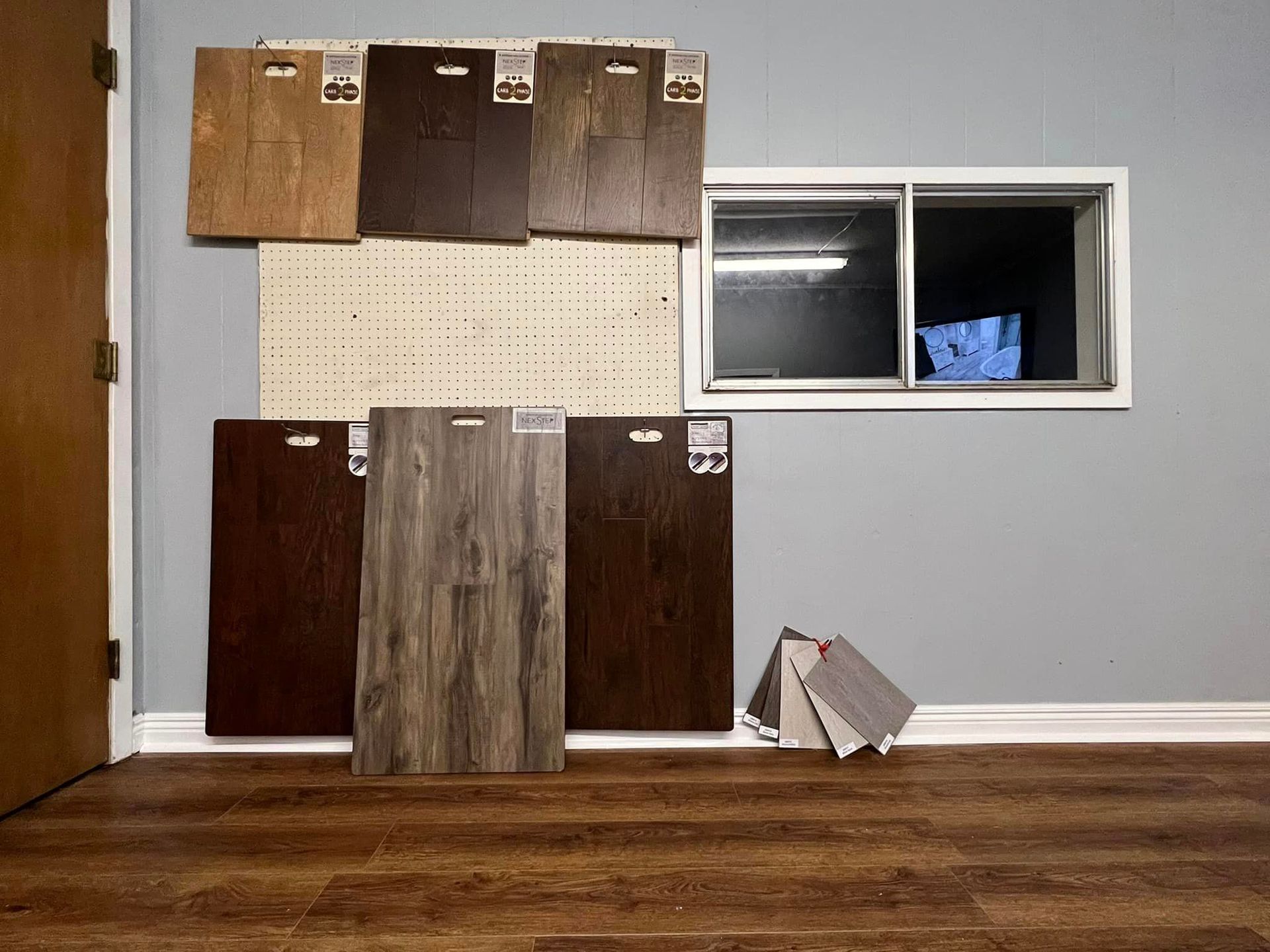 A room with a lot of wooden floors and a window.