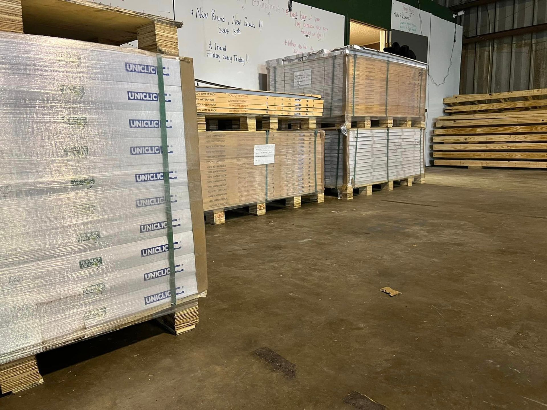 A warehouse filled with lots of wooden pallets and boxes.