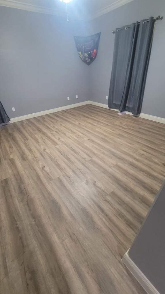 A living room with hardwood floors and gray walls.