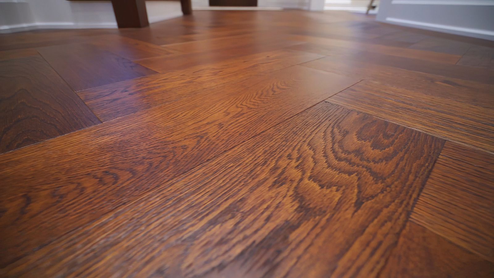 A close up of a wooden floor in a living room.
