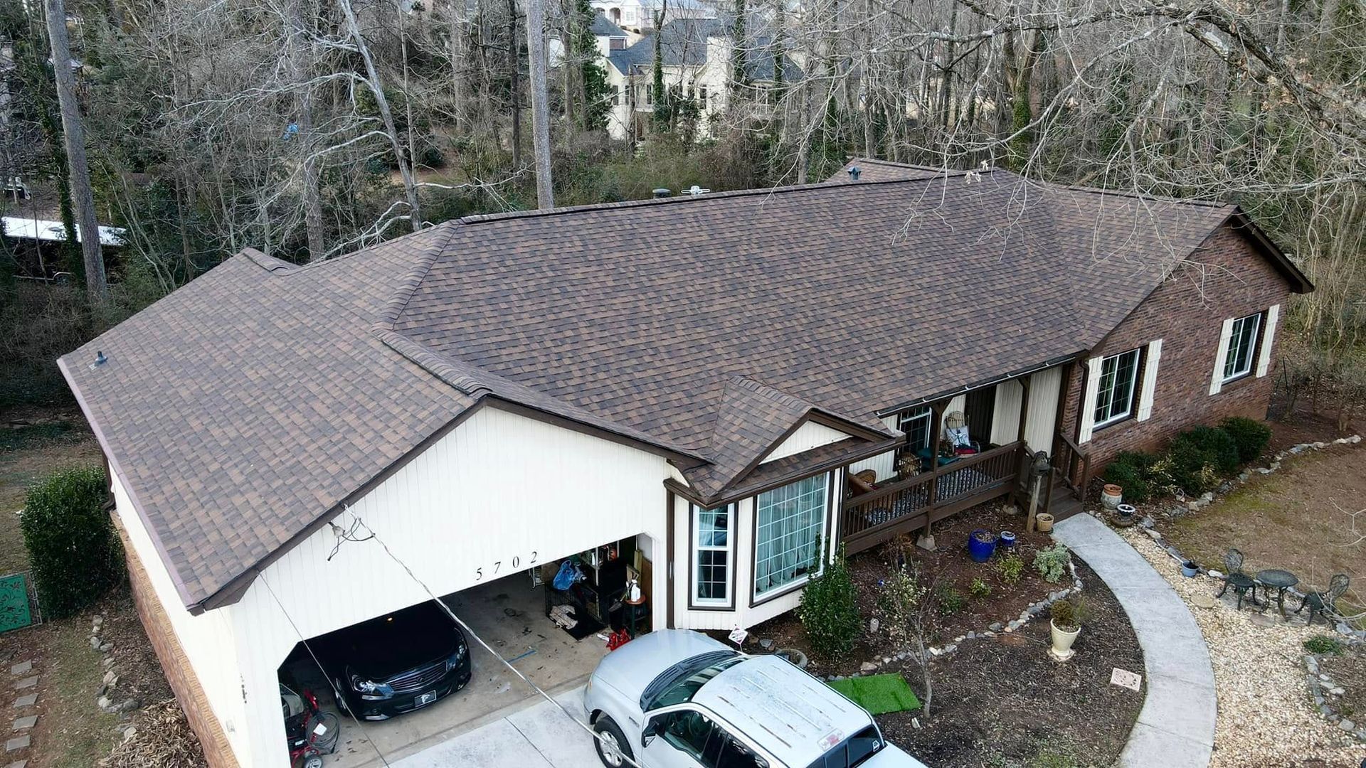 An aerial view of a house with a car parked in front of it.