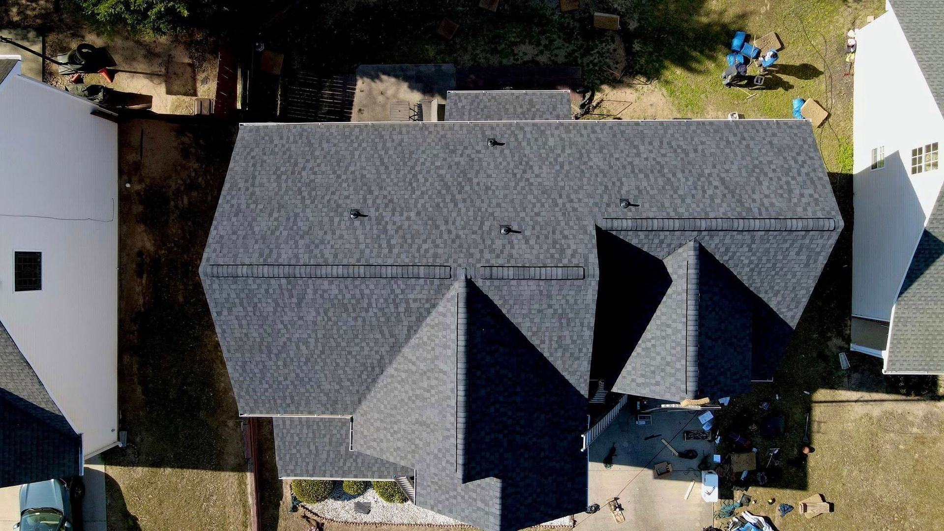 An aerial view of a house with a new roof.