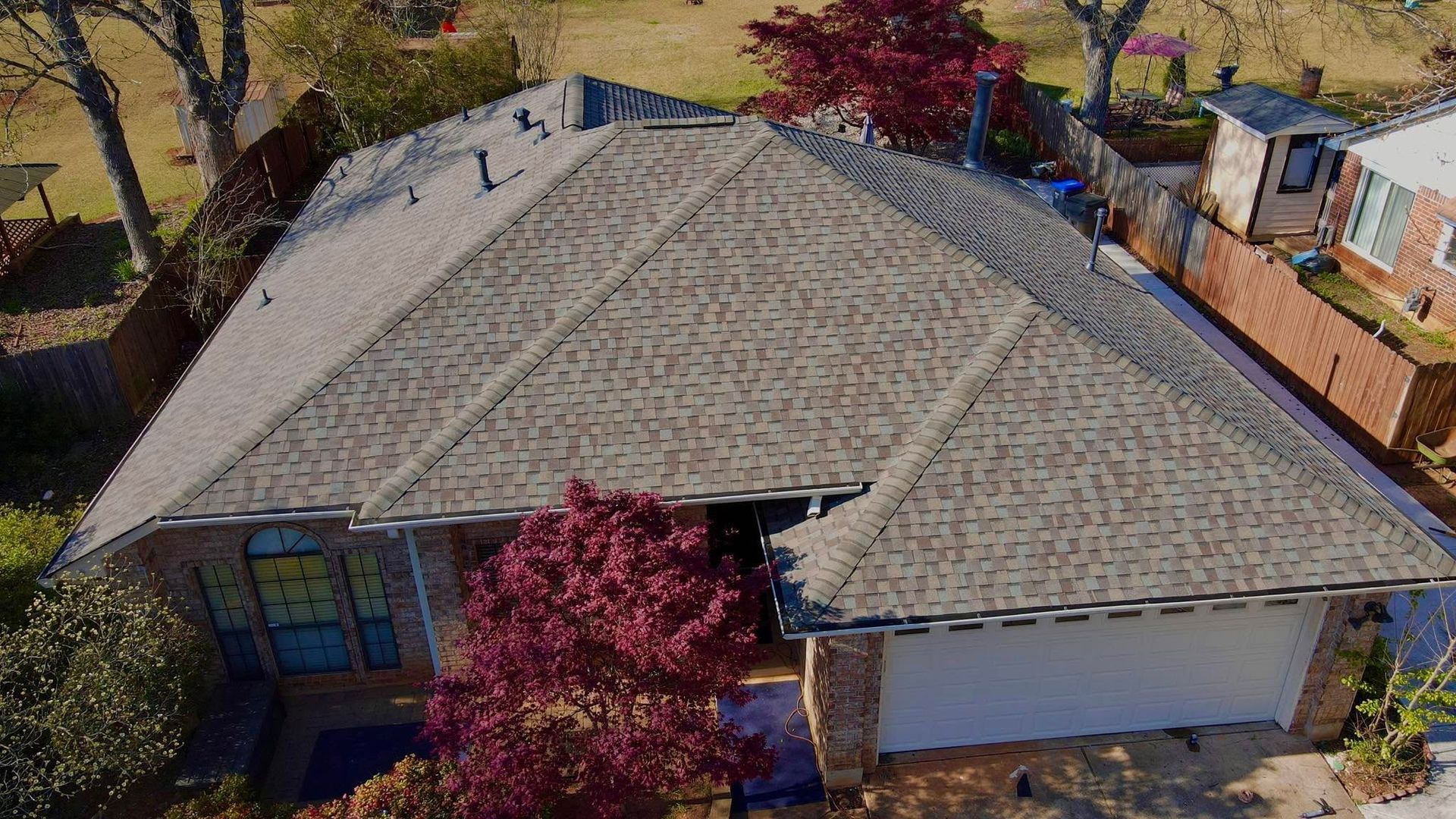 An aerial view of a house with a roof that is covered in shingles.